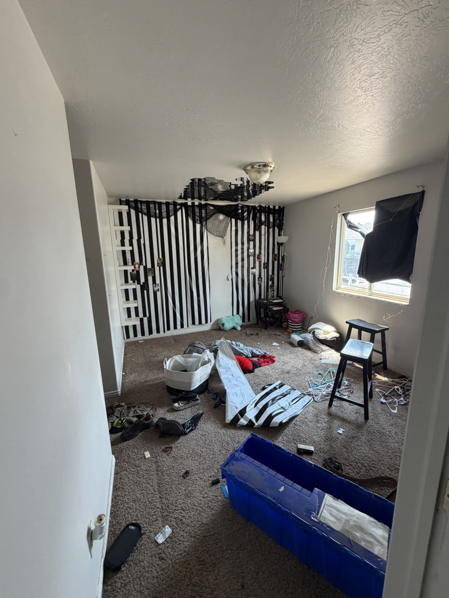 Bedroom with wall decorations and belongings before an Instahaul cleanout.
